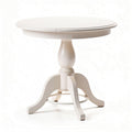 White round dining table made of wood with a pedestal base for small spaces